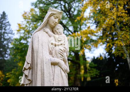 Eine Statue der Jungfrau Maria mit dem Jesuskind im Park des Benediktinerklosters in Clervaux, Luxemburg. Stockfoto