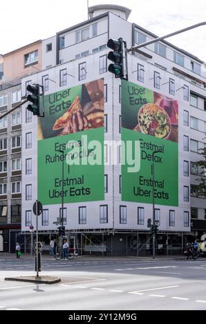 Großes Werbebanner, Fassadenverkleidung, während Bauarbeiten, macht Werbung für den Speisen Lieferdienst Uber Eats, Karlstraße, in Düsseldorf, NRW, Deutschland, Uber Eats *** große Werbebanner, Fassadenverkleidungen, während der Bauarbeiten, Werbung für die Lebensmittellieferfirma Uber Eats, Karlstraße, in Düsseldorf, NRW, Deutschland, Uber Isst Stockfoto