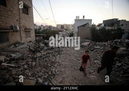 Jenin, Palästina. September 2024. Die Palästinenser fliehen aus ihren Häusern im Flüchtlingslager Dschenin im nördlichen Westjordanland, nachdem die israelischen Truppen sie in Kasernen verwandelt hatten, nachdem sie den siebten Tag auf die Stadt Dschenin und ihr Lager eingetreten waren. Quelle: SOPA Images Limited/Alamy Live News Stockfoto