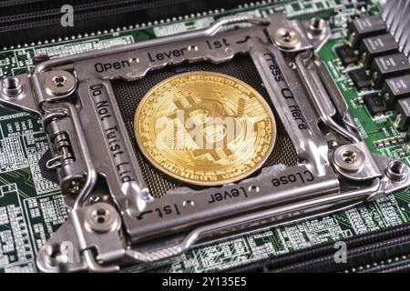 Golden Bitcoin Cryptocurrency auf der Computerplatine. Blockchain- und Sicherheitskonzept Stockfoto