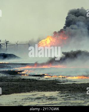 7. März 1991 Rohöl verbrennt und verschmutzt die Wüste und ein sabotierter Ölbrunnen bläst Flammen und Rauch im Burgan Ölfeld südlich von Kuwait City. Stockfoto