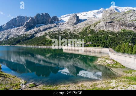 Fedaia See und Damm, Wasserspiegelung, Marmolada Massiv Gruppe Hintergrund mit Gletscher. Dolomiten-Pass Stockfoto