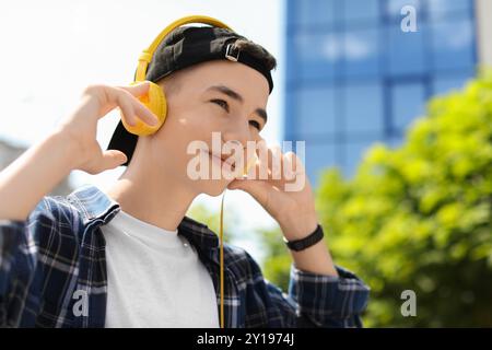 Porträt eines Teenagers mit Kopfhörern im Freien. Leerzeichen für Text Stockfoto