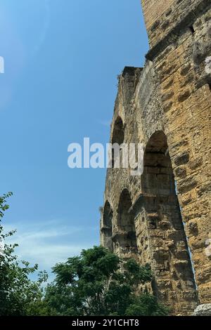 Detaillierte archäologische Ruinen des antiken römischen Aquädukts in Türkiye, Aphrodisias, Steinwasserbrücke, zweistöckige Mauer zwischen grünen Bäumen, Natur und Dörfern Stockfoto