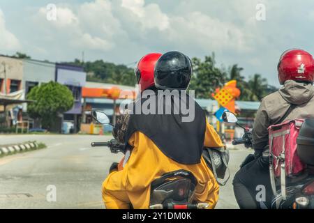 Kuala Lumpur, Malaysia. 25.08.2024. Traditionelle asiatische Straßen. Die Leute fahren Motorräder, um ihre Geschäfte zu erledigen Stockfoto