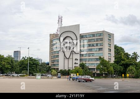 HAVANNA, KUBA - 28. AUGUST 2023: Gebäude des Ministeriums für Kommunikation Kubas (MINCOM) in Havanna (La Habana) mit Retro-Autos Stockfoto