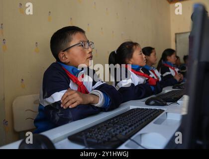 (240907) -- LHASA, 7. September 2024 (Xinhua) -- Konchog Rapten hat eine Computerklasse an der Central Primary School in Nyangpo Township im Gongbo'Gyamda County, Nyingchi, südwestchinesische Autonome Region Xizang, 3. September 2024. Konchog Rapten ist ein 10-jähriger Junge, der in der fünften Klasse an der Central Primary School im Gongbo'Gyamda County, Nyingchi, studiert. Seine Schule, die auf einer Höhe von fast 4.000 Metern liegt, ist die höchste Schule im County. Die Schule ist gut ausgestattet mit modernen Einrichtungen, darunter Klassenzimmer mit interaktiven Touchscreen-Lernsystemen und Heizung. Die Stockfoto