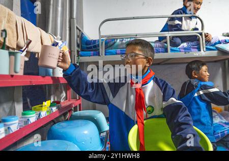 (240907) -- LHASA, 7. September 2024 (Xinhua) -- Konchog Rapten bereitet sich darauf vor, sich im Schlafsaal der Zentralen Grundschule in Nyangpo Township des Gongbo'Gyamda County, Nyingchi, südwestchinesische Autonome Region Xizang, am 3. September 2024 zu waschen. Konchog Rapten ist ein 10-jähriger Junge, der in der fünften Klasse an der Central Primary School im Gongbo'Gyamda County, Nyingchi, studiert. Seine Schule, die auf einer Höhe von fast 4.000 Metern liegt, ist die höchste Schule im County. Die Schule ist gut ausgestattet mit modernen Einrichtungen, darunter Klassenzimmer mit interaktiven Touchscreen-Lehrsystemen Stockfoto