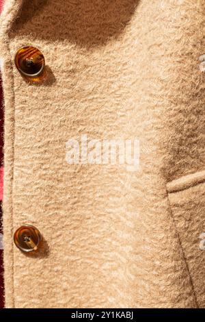 detail of a beige wool pressed coat in a clothing shop for sale, autumn fashion Stockfoto