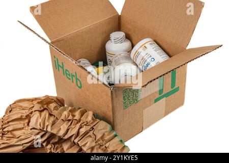 Lviv Ukraine 08.17.24 offene iHerb-Box mit Vitaminen auf weißem Hintergrund Stockfoto