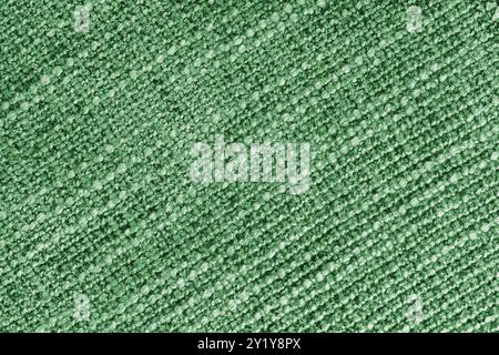 Grüne Polsterung mit Jacquard-Diagonalgewebe und grober Webstruktur. Textilhintergrund, Möbel Textilmaterial, Tapete, Hintergrund. Stoffauflage Stockfoto