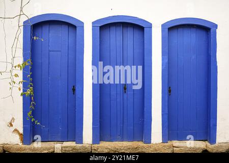 Hausfassade mit drei typischen blauen Holztüren in der zum UNESCO-Weltkulturerbe gehörenden Stadt Paraty, Brasilien, Südamerika Stockfoto