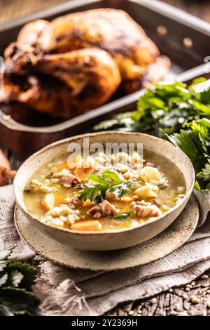 Suppe aus Gerstengrieß, geräuchertem Schweinehals, Kartoffeln und Wurzelgemüse. Stockfoto