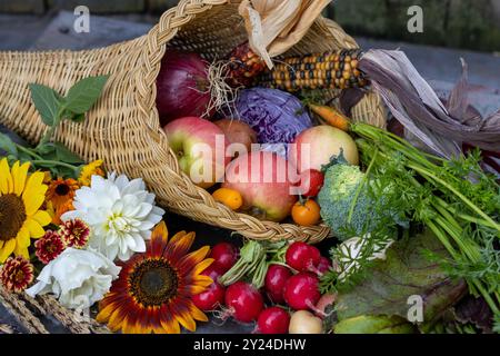 Fruchtblumen, die mit Herbstfrüchten, Gemüse und Blumen überflutet sind Stockfoto