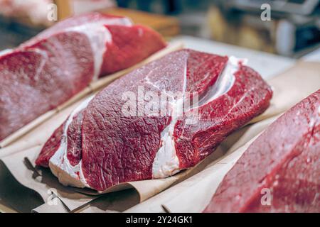 Drei Fleischstücke werden auf einer Theke ausgestellt Stockfoto