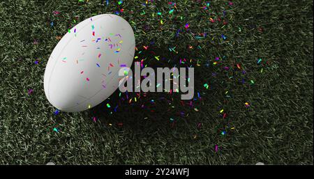 Bild von Konfetti über weißem Rugbyball auf Gras Stockfoto