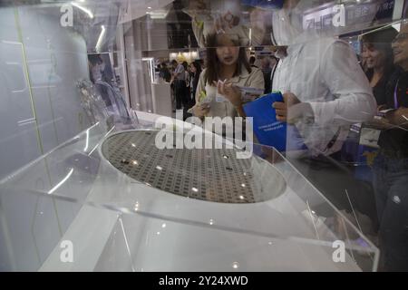 Besucher beobachten verschiedene Siliziumwafer, die während der SEMICON Taiwan im Nangang Exhibition Center in Taipei, Taiwan, im September 6,2024 gezeigt werden. Stockfoto