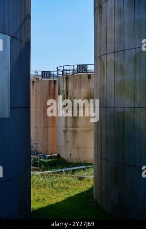 Verwitterte Öltanks mit Pazina im Sonnenschein Stockfoto