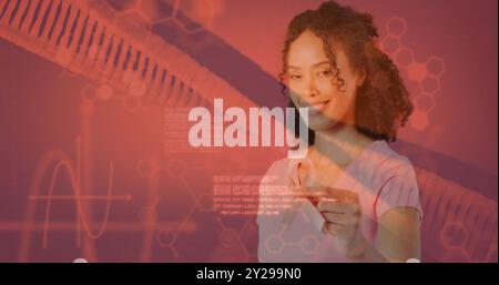 Bild von dna-Strang und Datenverarbeitung über afroamerikanischer Frau mit rosa Schleife Stockfoto
