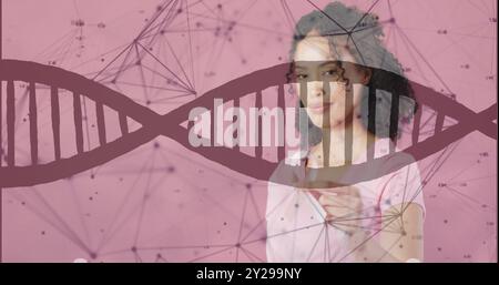 Bild von dna-Strang und Datenverarbeitung über afroamerikanischer Frau mit rosa Schleife Stockfoto
