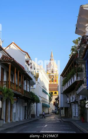 Blick auf den Uhrenturm der Kathedrale von Cartagena mit blauem Himmel durch eine schmale Gasse im Schatten, Cartagena, Kolumbien, UNESCO-Weltkulturerbe, South Amer Stockfoto