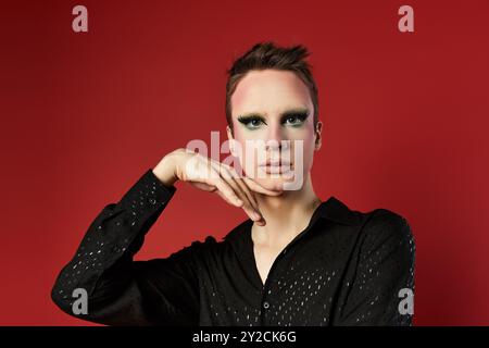 Ein junger Drag-Performer zeigt Mode und Kunst durch dynamische Posen. Stockfoto