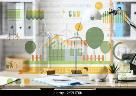 Windturbinenmodelle mit Schweinebank auf dem Tisch im Büro. Konzept der grünen Energie Stockfoto