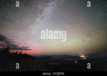 Airglow, die Milchstraßengalaxie und die schwache aurora Borealis, die am Nachthimmel von der Spitze des Signal Mountain glänzen. Grand Teton National Park, Wyoming Stockfoto