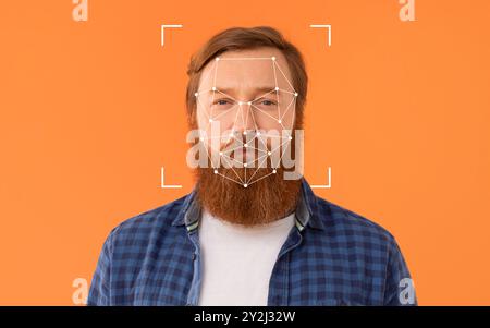 Mann mit Gesichtserkennungstechnologie auf orangefarbenem Hintergrund Stockfoto