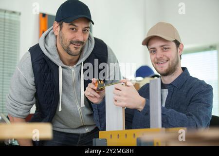 Zwei Männer arbeiten beim Schneiden von Sperrholzplatten Stockfoto
