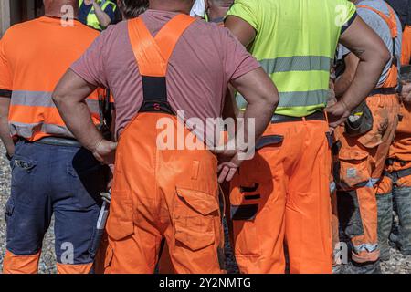 Hamburg, Deutschland. August 2024. Eine Gruppe von Bauarbeitern steht während einer Pause auf einer Baustelle zusammen. Quelle: Markus Scholz/dpa/Alamy Live News Stockfoto