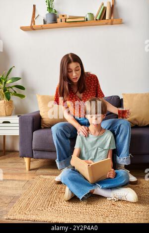 Eine Mutter verwickelt ihren hörgeschädigten Sohn in einen reizvollen Lesepublick. Stockfoto