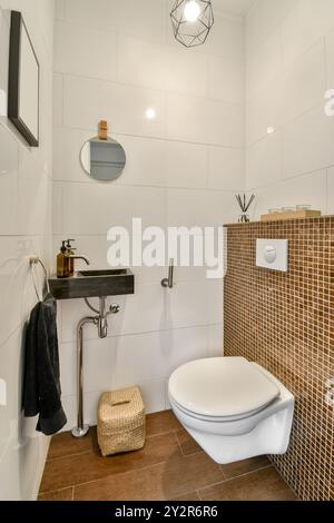 Modernes Badezimmer mit geometrischen Beleuchtungselementen und Mosaikfliesen. Stockfoto