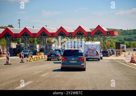 Kroatien - 25. August 2024: Mautstation in Kroatien: Urlauber und Reisende passieren die Gebührenstation auf dem Weg zu ihren Sommerzielen, darunter viele Wohnmobile und Autos mit Fahrrädern *** Mautstation in Kroatien: Urlauber und Reisende passieren die Gebührenstation auf dem Weg zu ihren Sommerzielen, darunter viele Wohnmobile und Autos mit Fahrrädern Stockfoto