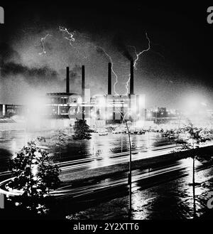 REKORDDATUM NICHT ANGEGEBEN Gewitter über das Volkswagenwerk in Wolfsburg - wie ihier in der Oelkrise 1973. Im Foto: das alte VW Kraftwerk mit den 4 Schornsteinen und vorn die Heinrich Nordhoff Str. mit VW Parkplatz für Mitarbeiter *** Gewitter über dem Volkswagen Werk in Wolfsburg wie hier in der Ölkrise 1973 auf dem Foto das alte VW-Kraftwerk mit den 4 Schornsteinen und davor die Heinrich Nordhoff Str mit VW Parkplatz für Mitarbeiter Stockfoto