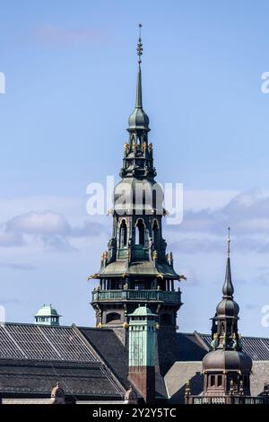 Aus nächster Nähe sehen Sie das Nordic Museum, den kunstvoll verzierten Turm eines historischen Gebäudes vor einem klaren blauen Himmel. Der Turm verfügt über komplexe architektonische Details Stockfoto