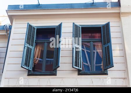 Zwei Fenster mit Holzläden am alten Haus Stockfoto