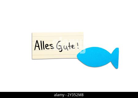 Alles Gute! Deutsches Wunschwort zur Kommunion auf beigefarbenem Papier, handgeschrieben. Blauer Fisch in der Ecke. Isoliert auf weiß. Freier Platz für Text. Stockfoto