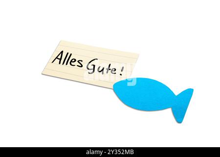 Alles Gute! Deutsches Wunschwort zur Kommunion auf beigefarbenem Papier, handgeschrieben. Blauer Fisch in der Ecke. Isoliert auf weiß. Freier Platz für Text. Stockfoto