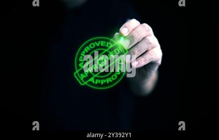 Geschäftsmann Hand mit Eingabestift, die auf ein leuchtend grünes, genehmigtes Stempelzeichen tippen, das eine Genehmigung für Dokument, Geschäftsprojekt und Bewertung darstellt Stockfoto