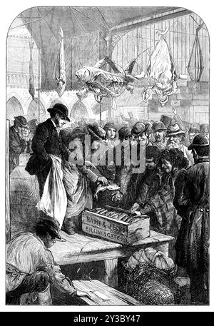 Eine Fischauktion auf dem Columbia Market, [East London], 1871. '...das prächtige Gebäude, bekannt als Columbia Market... wurde von Lady Burdett-Coutts für einen Preis von über 200.000...[es] wurde der Corporation of London in ständigem Vertrauen gegeben, um den ärmeren Klassen als Markt für billige Lebensmittel zu dienen, mit einer besonderen Empfehlung, den Verkauf von Fisch zu fördern und durch alle zweckmäßigen Vorkehrungen zu unterstützen. Eine Illustration zeigt nun die Szene dort, die zu einer frühen Stunde des morgens beobachtet werden kann, als die erste Ladung FIS Stockfoto