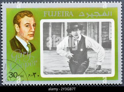 Gestempelte Briefmarke, gedruckt von Fujairah (Fujeira), die Filmstar Gary Cooper zeigt, um 1972. Stockfoto