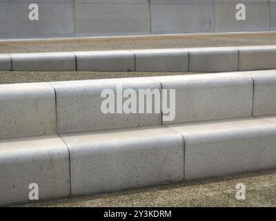 Moderne abgewinkelte Außentstufen mit abgerundeten Ecken in Grau- und Brauntönen Stockfoto