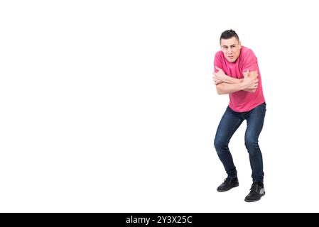 Zitternder Mann, der im Studio mit gekreuzten Armen steht Stockfoto