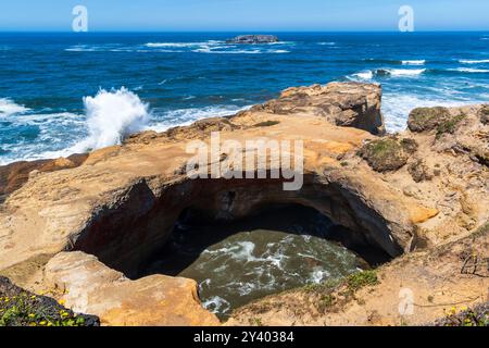 Wellen brechen auf Rocks, Devils Punchbowl, Oregon Coast, USA Stockfoto