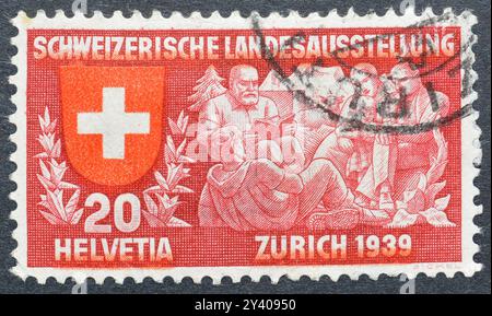 Gestempelte Briefmarke, gedruckt von der Schweiz, die den Besuchern einen Dichter zuhört, Schweizer Ausstellung, um 1939. Stockfoto