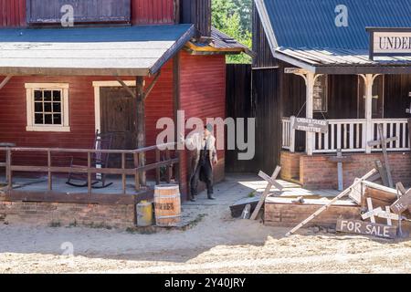 Mann, der sich hinter einer Mauer in der Stadt versteckt Stockfoto