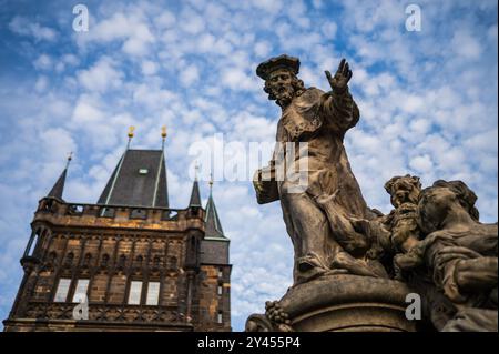 Statue des Heiligen Ivo von Kermartin und alter Turm an der Karlsbrücke in Prag Stockfoto