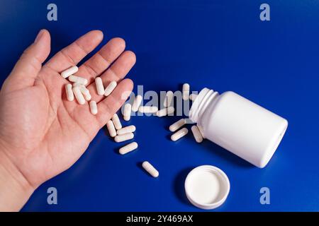 Hand einer Person, die Suizid mit Schlaftabletten verabreicht hat Stockfoto