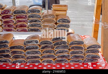 Stapel hausgemachter schwarzer Mohnkuchen zum Verkauf auf dem Bauernmarkt Stockfoto